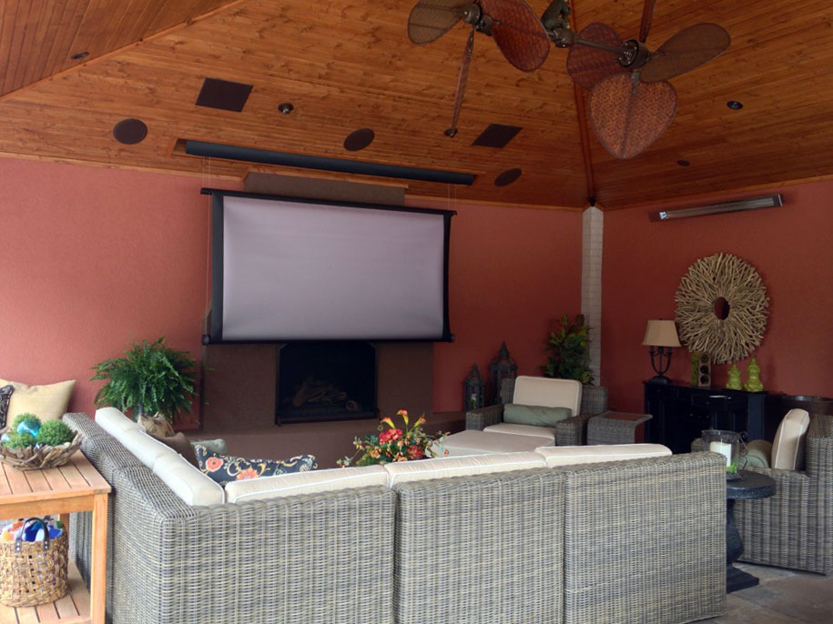 Outdoor home theater system and couch featuring professional electrical wiring