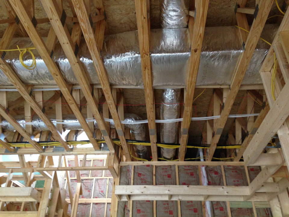 Heat pump and wiring inside a new home construction site showing the tremendous work of Thompson